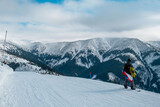 Fototapeta Natura - man snowboarder with slovakia flag at ski resort slope
