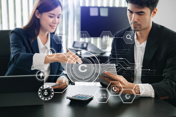 Wall Mural - Copyright or patent concept, Business team analyzing data and using smart phone and tablet with virtual screen copyright icon trademark license, Creation ownership against piracy.