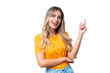 Young Uruguayan woman over isolated background happy and pointing up