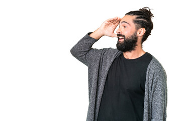 Wall Mural - Young man with beard over isolated chroma key background with surprise expression while looking side