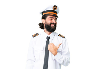 Wall Mural - Airplane caucasian pilot man over isolated chroma key background pointing to the side to present a product