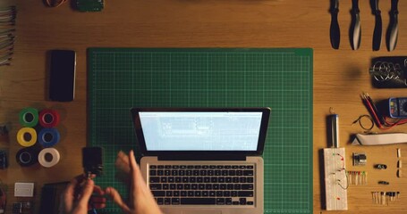 Laptop hacking, hands and technician with hardware, screen and coding software system for upgrade, cyber security or electronics career. Computer, pc or technology expert working on circuit and tools