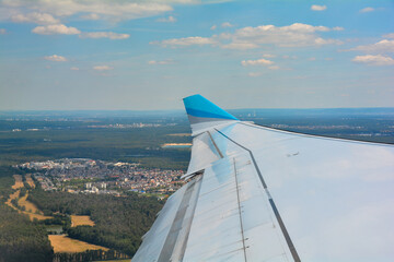 View from an aircraft window shortly after take-off with a view of the wing and landscape from the Frankfurt am Main area, Germany