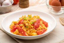 Stir Fried Egg With Tomato,Scrambled Eggs With Tomatoes On White Plate