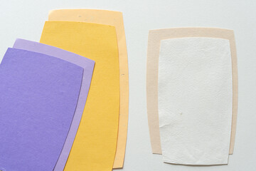 Wall Mural - violet, yellow, and white/ivory paper shapes on blank paper