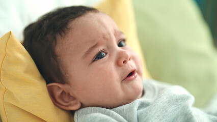 Canvas Print - Adorable hispanic baby lying on bed crying at bedroom