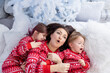 © Olena - People in same family look pajamas, kidding at home christmas day. New Year holidays. Happy funny child boy son, daughter, girl with mother spend time together, enjoying, fool around in bed in bedroom