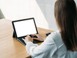 © golubovy - Distance work. Computer mockup. Digital life. Elegant female typing laptop white blank screen sitting desk in light room interior.