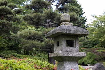 Canvas Print - Traditional Japanese toro lantern made of stone placed in a forest