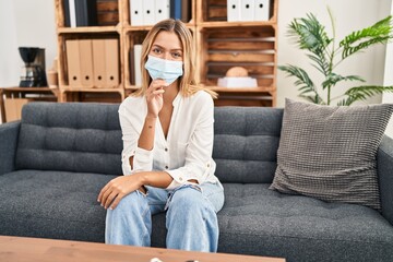 Poster - Young blonde woman treating covid fear at therapy smiling looking confident at the camera with crossed arms and hand on chin. thinking positive.