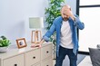 Young bald man suffering dizzy standing at home