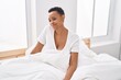 © Krakenimages.com - African american woman smiling confident sitting on bed at bedroom