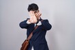 © Krakenimages.com - Hispanic man with beard wearing business clothes rejection expression crossing arms and palms doing negative sign, angry face