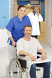 © auremar - happy nurse talking care of a happy patient in wheelchair