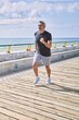© Krakenimages.com - Middle age hispanic man wearing sportswear running at seaside