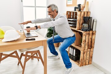 Wall Mural - Middle age grey-haired man architect smiling confident training at office