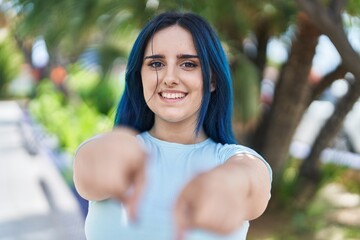 Sticker - Young caucasian woman smiling confident pointing with fingers to the camera at park