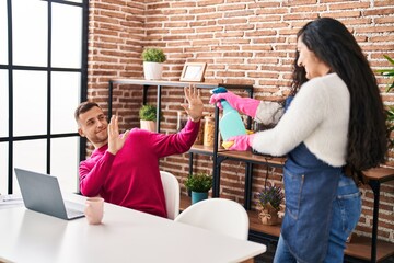 Poster - Man and woman couple using laptop and doing chores at home