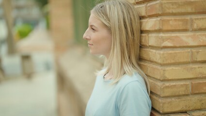 Sticker - Young blonde woman looking to the side with serious expression at street