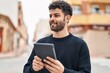 © Krakenimages.com - Young arab man smiling confident using touchpad at street