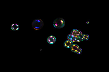 Sticker - Soap bubbles isolated on a black background.