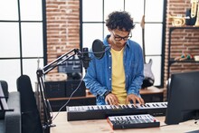 Young Hispanic Man Musician Playing Piano Keyboard At Music Studio