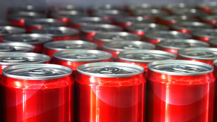 Close-up of many red cans standing in a rows