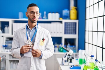 Sticker - African american man scientist holding dollar at laboratory