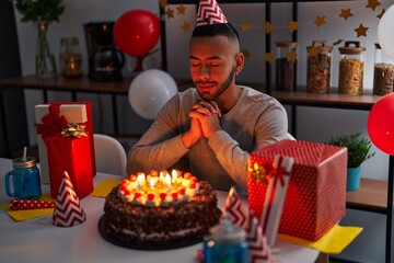 Canvas Print - African american man celebrating birthday having wish at home