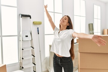 Wall Mural - Young hispanic woman smiling confident standing at new home