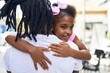 © Krakenimages.com - Father and daughter smiling confident hugging each other at coffee shop terrace