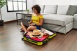 Young hispanic woman using laptop preparing summer travel at home