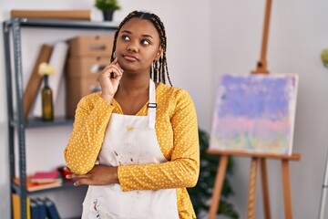 Poster - African american woman with braids at art studio serious face thinking about question with hand on chin, thoughtful about confusing idea