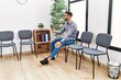 © Krakenimages.com - Young arab man using smartphone sitting on chair at waiting room