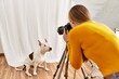 © Krakenimages.com - Young caucasian woman photographer making photo to dog at photography studio