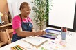 © Krakenimages.com - Senior african american woman smiling confident drawing at art studio