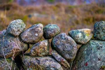 Old stone fence  by an open field.