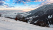 © Pellinni - carpathian rural landscape in winter. beautiful sunrise in mountains. snow covered hills. scenery with krasna ridge in the distance. synevir village in the valley