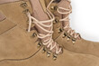 Shoe lacing of beige leather combat boots, fragment close-up