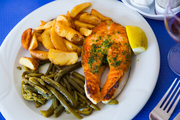 Wall Mural - Healthy dinner, grilled salmon fillet with roasted potatoes, stewed green beans and lemon