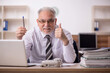 © Elnur - Old male boss employee working in the office