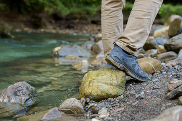 Poster - Men's sneakers on the beach of river 