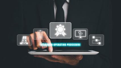 SOP,  Standard Operating Procedure concept, Businessman hand touching digital tablet with SOP icon on virtual screen.