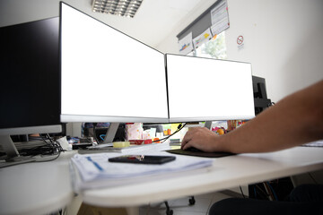 two screens in an office with white background. mockup desk in the office.