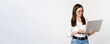 © Mix and Match Studio - Portrait of young office woman, entrepreneur answer clients on laptop, working with computer with happy face, standing over white background