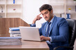 © Elnur - Young male employee and too much work in the office
