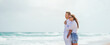 © travnikovstudio - Young couple in love on the beach summer vacation. Happy man and woman look at the sea