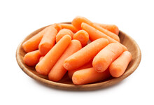 Close Up Pile Of Baby Small Carrots In Wood Plate Isolated On White Background. Small Baby Carrots, Fresh Baby Carrots                               