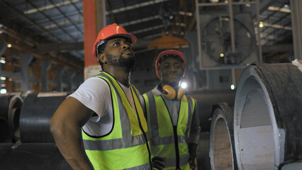 Portrait of two African American men wearing a safety vest and helmet