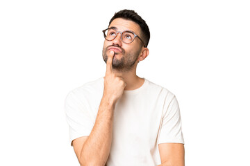 young handsome caucasian man over isolated chroma key background having doubts while looking up